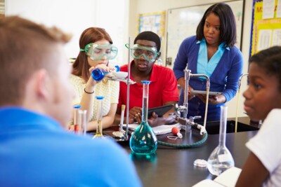 Pupils Carrying Out Experiment In Science Class